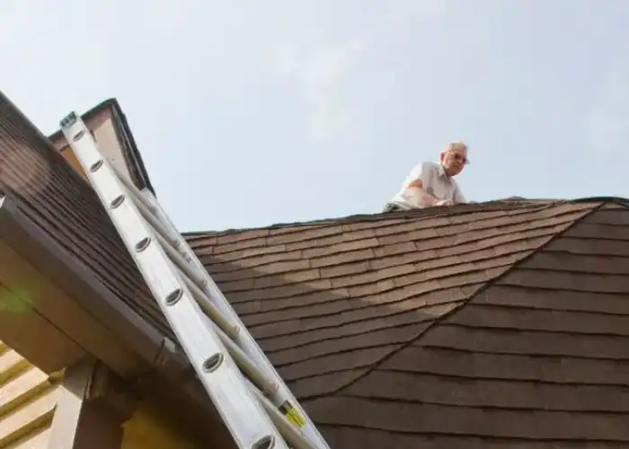 Man is inspecting the roof installation and roof siding